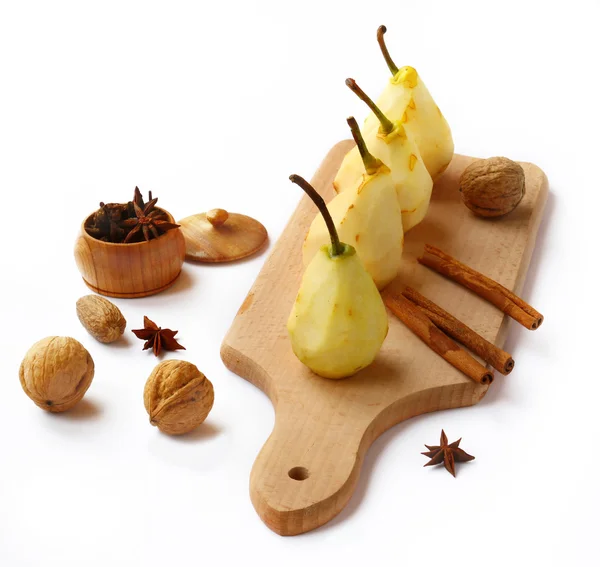 Four cleaned pears for preparation of dessert and walnuts — Stock Photo, Image