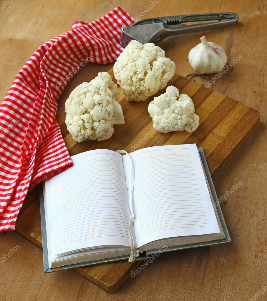 Open notebook with cauliflower and garlic