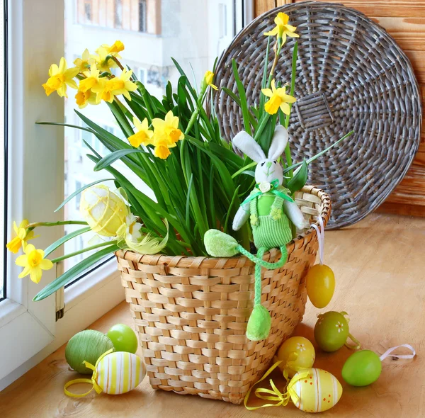 Narciso con un conejo de Pascua y los huevos en una cesta —  Fotos de Stock