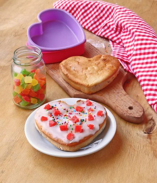 Cookies in the form of heart and a jar with the candied fruits — Stock Photo, Image