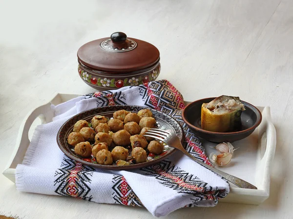 Dumplings and fish on a wooden tray — Stock Photo, Image