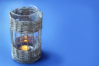 Vintage wicker lamp with a candle on the eve clipart