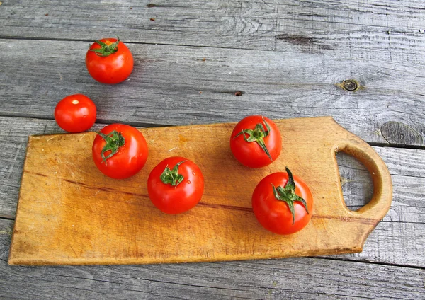 Tomato on vintage table — Stock Photo, Image