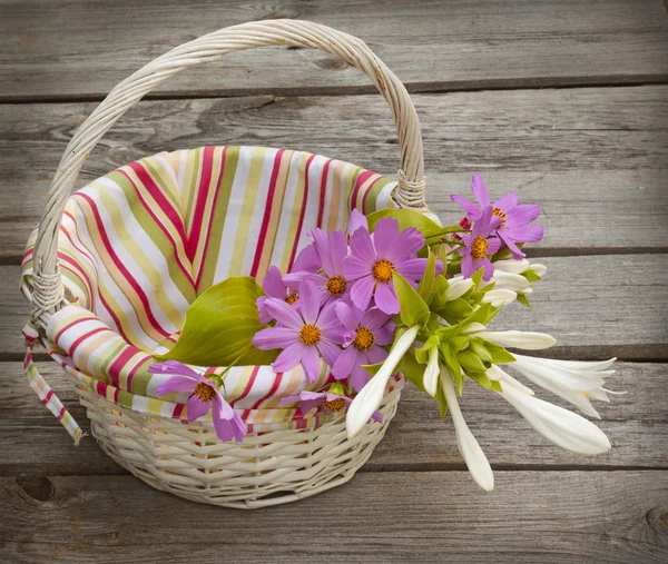 Hosta and cosmos in a basket — Stock Photo, Image