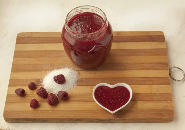 Bank with raspberry jam on the table — Stock Photo, Image