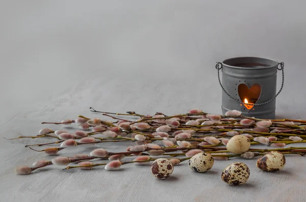 Willow bunch with candle and quail eggs — Stock Photo, Image