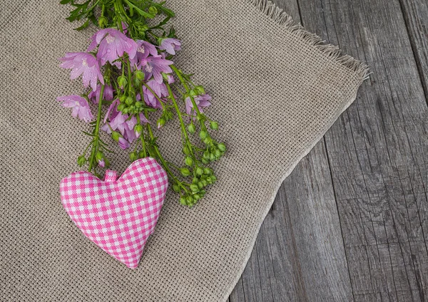 Bir buket pembe ebegümeci ve kalp rustik natürmort — Stok fotoğraf