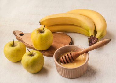 Vegetarian healthy breakfast of apples, bananas and honey. Ingredients for vitamin cocktails  