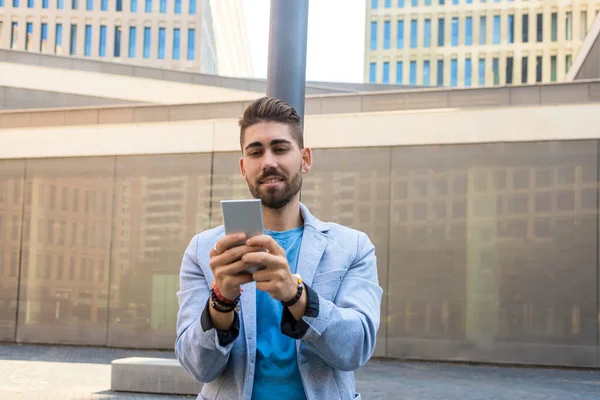 Handsome Man Smiling Using His Mobile Phone — Stock Photo, Image