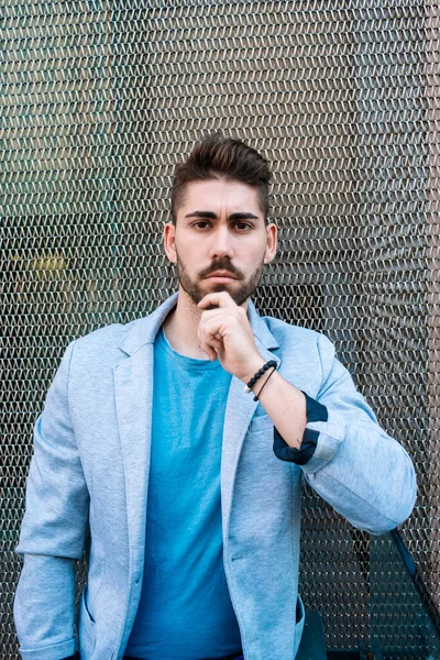 Bearded man, model of fashion, in urban background wearing casual clothes.