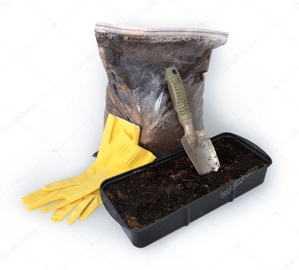 Gardening trowel, gloves, bag with peat, container for seedlings