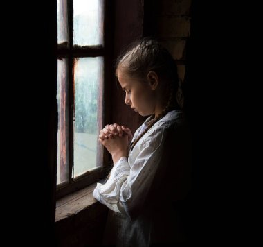 Cute light worry anxious ancient little human Ukrainian war pauper waif face trust dream. Rural Ukrainian dirty cold retro dark black old home room wall small misery teen grief cry concept text space