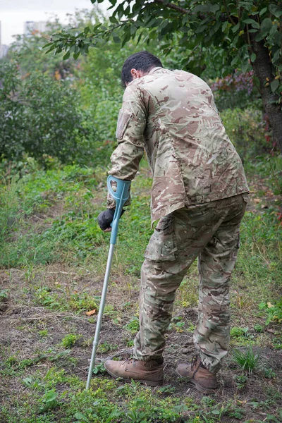 Russia army force guard stress pain repent think young male guy camo uniform foot leg protect go fall park yard field. Lone human cry god care arm bone invalid failure vet warrior fighter hero back view