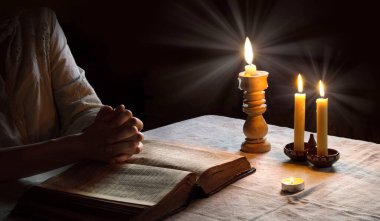 Bless hope human girl sacred thank ask Jesus Christ teach open new biblical paper page word text space. Retro young male guy boy student fold finger arm dark black night fire flame light Israel church