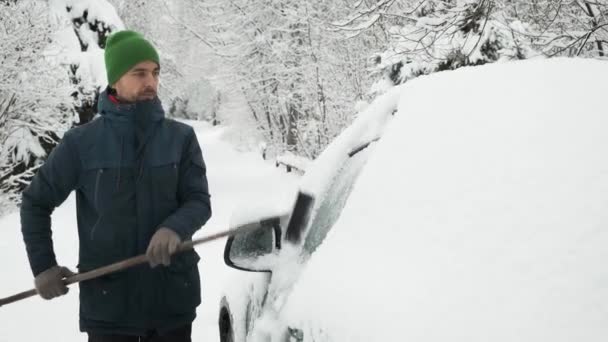 Hombre Limpiando Coche Cubierto Nieve Con Cepillo Después Fuertes Nevadas — Vídeo de stock