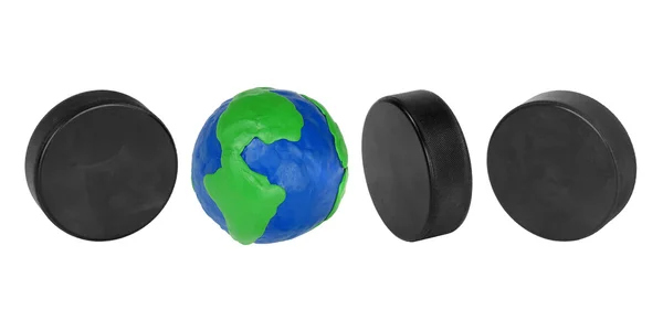 Hockey pucks and plasticine globe — Stock Photo, Image