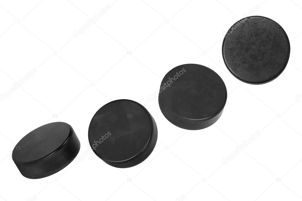Four hockey pucks