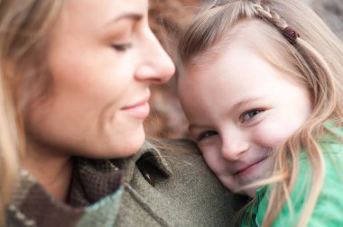 utangaç gülümseyen kız annesi ile