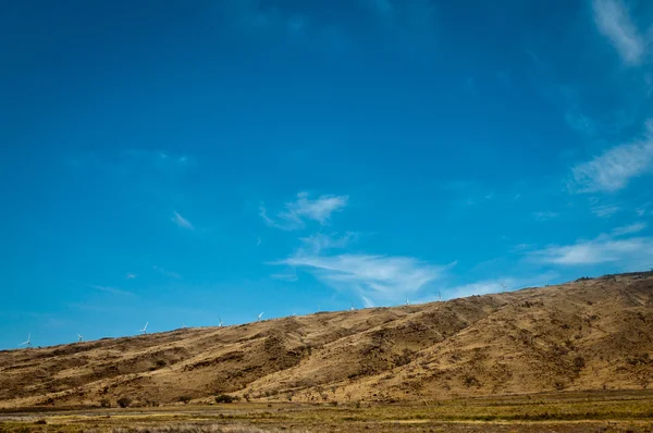 Kuru bir tepe üzerinde uzak Rüzgar türbinleri — Stok fotoğraf