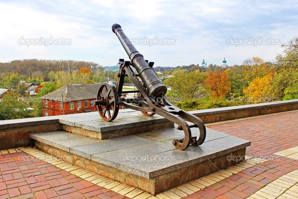 Old cannon in Chernigov and autumn park as background
