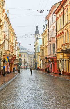 Kobylianska street in Chernivtsi, Ukraine in the rainy weather clipart