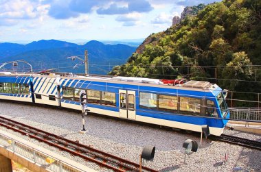 Train arrives to famous Montserrat monastery in Spain clipart