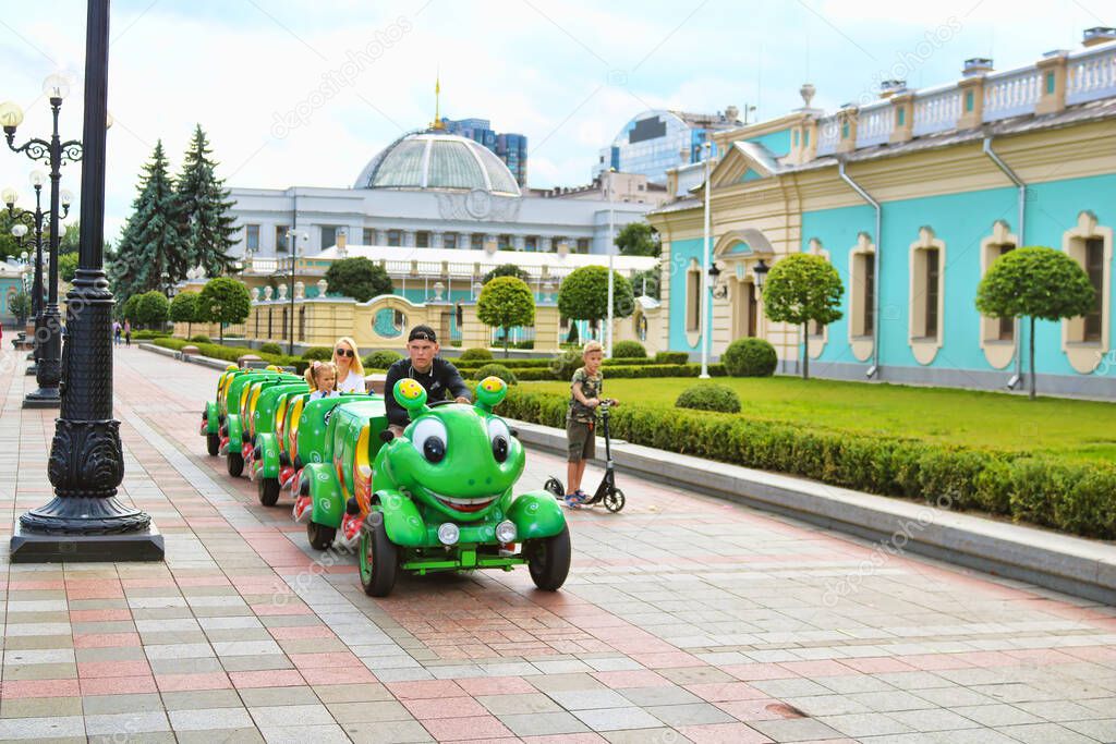 Kyiv, Ukraine - July 13, 2019: Children train like a caterpillar in the Mariinskyi Park near the Mariinskyi Palace
