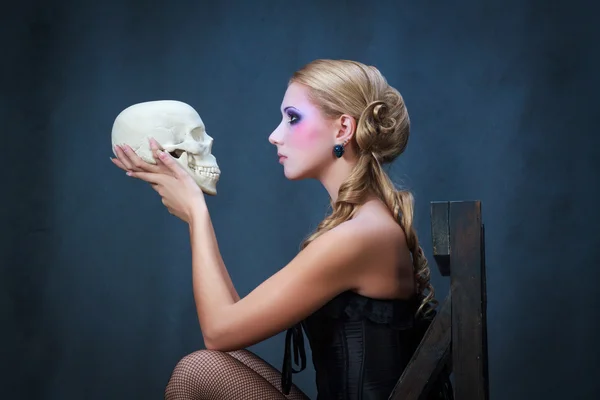 Mujer con cráneo, filmada en el estudio Fotos de stock