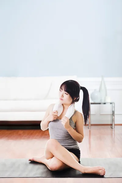 Asian woman resting after workout. Royalty Free Stock Images