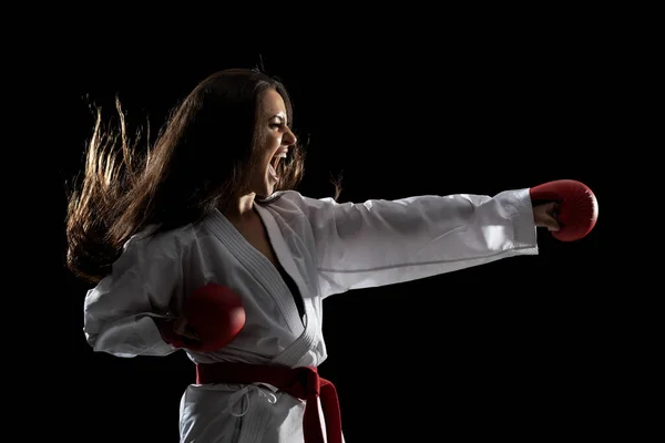 Flicka Tränar Karate Punch Och Skriker Mot Svart Bakgrund — Stockfoto