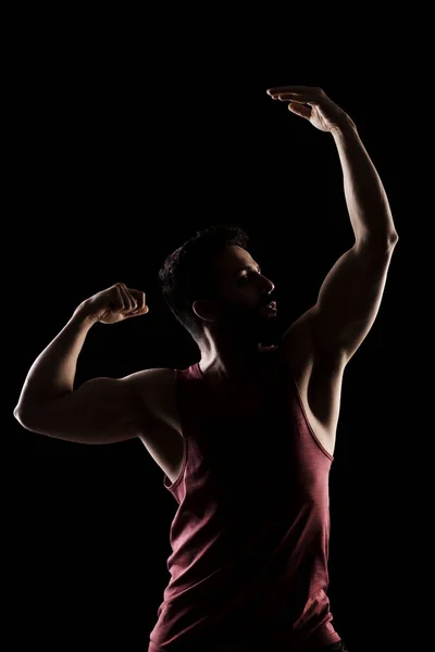Side Lit Muscular Caucasian Man Silhouette Athlete Red Shirt Posing Stock Photo