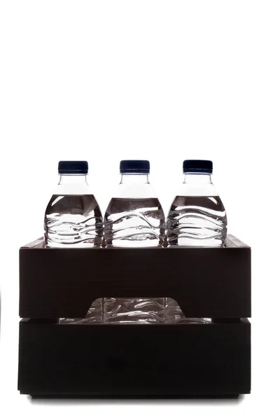 Group Small Plastic Water Bottles Wooden Crate Studio Photo Silhouette — Zdjęcie stockowe