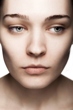 Beyaz arka plana karşı güzel bir genç kadının stüdyo portresini kapat.