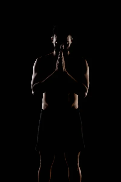 Seitlich Beleuchtete Muskulöse Kaukasische Männersilhouette Sportler Betet Vor Schwarzem Hintergrund — Stockfoto
