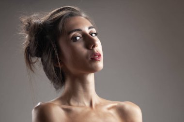 Güzel esmer kız stüdyo resmi. Ciddi yüz ifadesi.