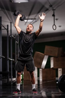 Kas sporcusu çok ağır ağırlık kaldırıyor. Adam içeride çalışıyor.
