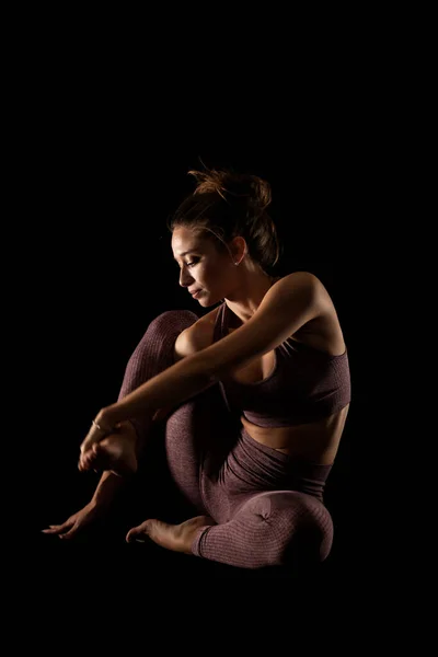 适合练习瑜伽的女人 侧光半影女孩在有黑色背景的工作室里做运动 — 图库照片