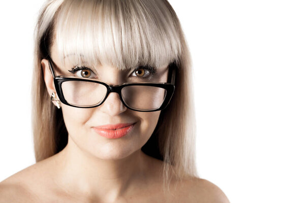 Portrait of a beautiful brunette girl with blond bangs fringe. Wearing glasses.