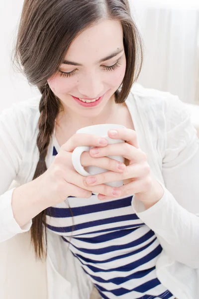 Aantrekkelijke jonge vrouw drinken koffie in Bank — Stockfoto