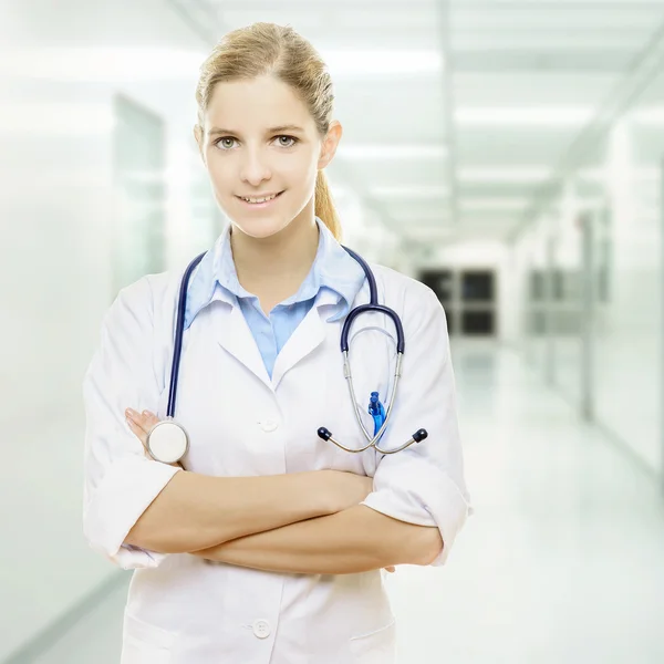 Female doctor smiling with arms crossed Stock Image