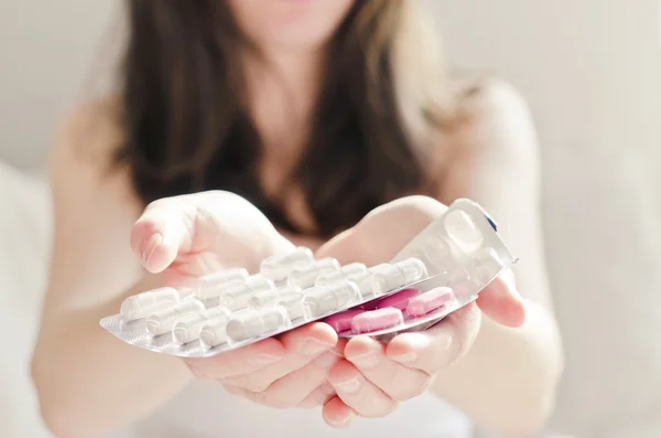 Woman holding pharmaceuticals — Stock Photo, Image