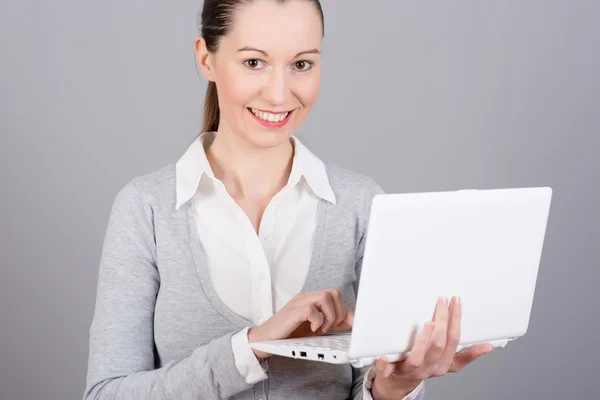 Businesswoman holding a laptop — Stock Photo, Image