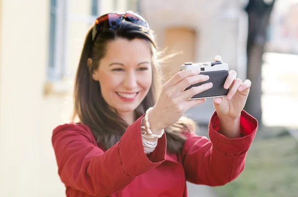 Beautiful smiling girl with camera — Stock Photo, Image