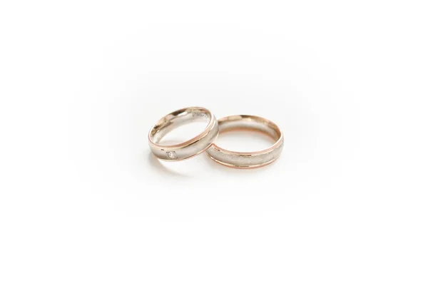 Золотые обручальные кольца на маленькой белой подушке — стоковое фото