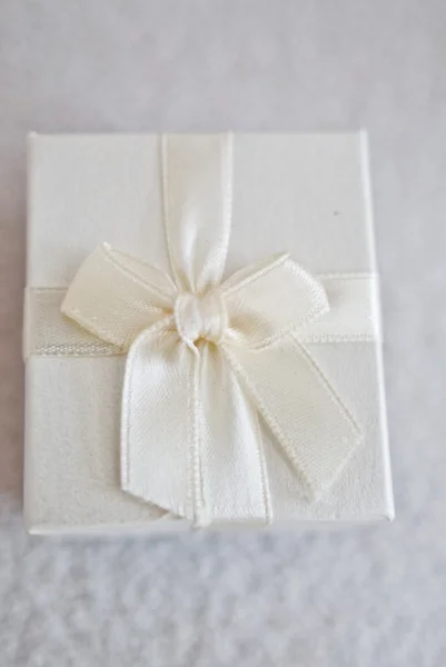 Confezione regalo bianca con nastro e fiocco in tessuto bianco — Foto Stock