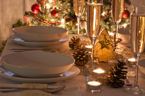 A decorated christmas dining table with champagne glasses