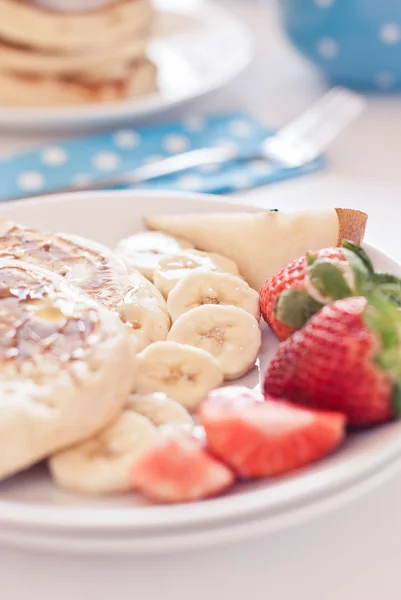 Delicious pancakes on morning breakfast table with fruits — Stock Photo, Image