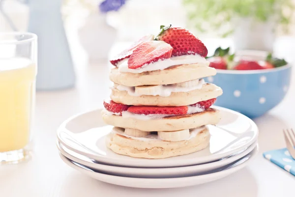 Delicious pancakes on morning breakfast table with fruits — Stock Photo, Image