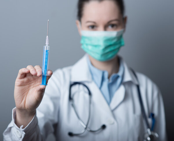 Female doctor preparing syringe