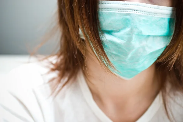 Attractive young lady with a face mask — Stock Photo, Image